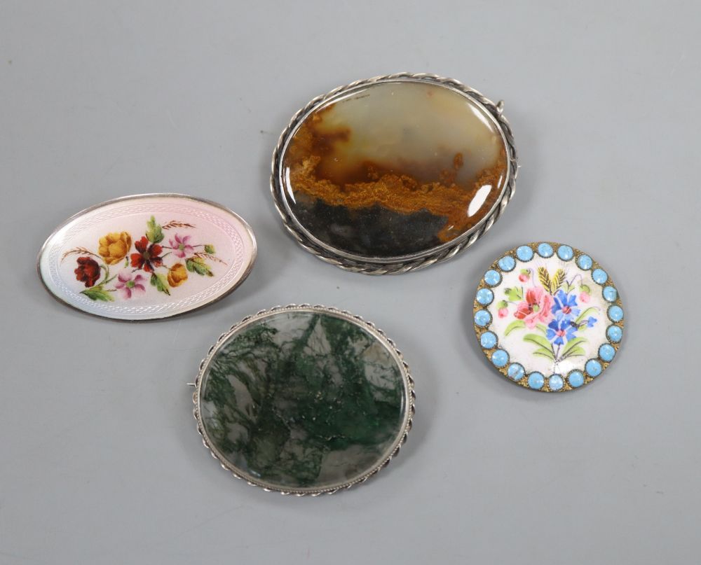 Two white metal mounted moss agate brooches, largest 51mm and two other enameled items including white metal brooch.